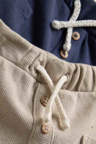 Baby: jongens - Set van 2 - babyjoggingbroek - met structuur - blauw / beige