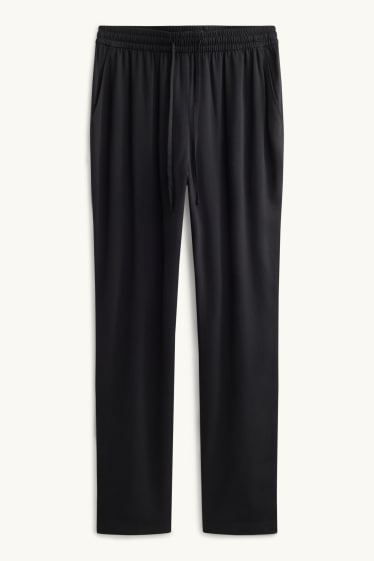 Dona - Pantalons de tela - mid waist - tapered fit - negre