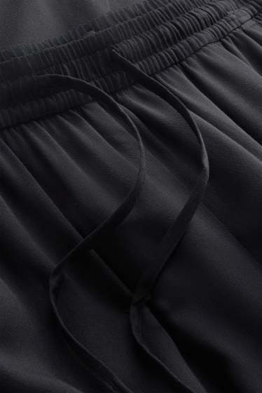 Dona - Pantalons de tela - mid waist - tapered fit - negre