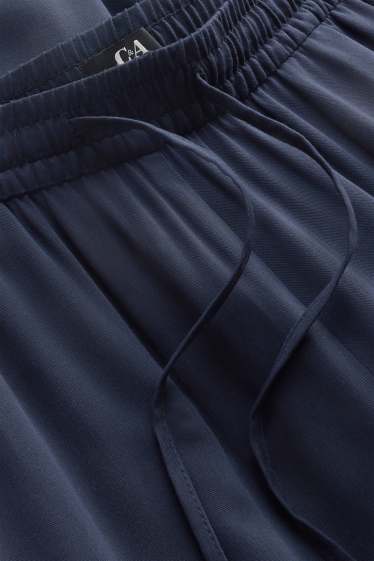 Dona - Pantalons de tela - mid waist - tapered fit - blau fosc