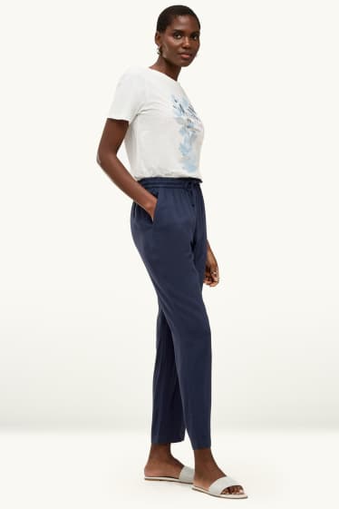 Dona - Pantalons de tela - mid waist - tapered fit - blau fosc