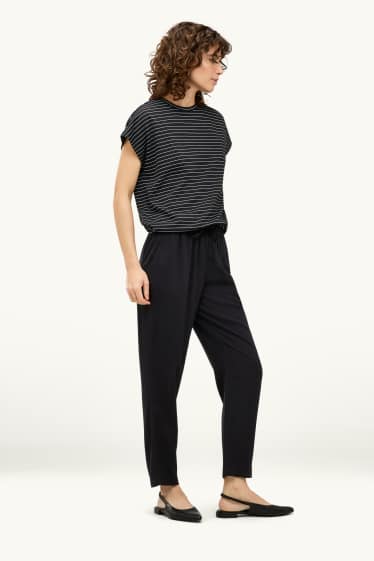 Dona - Pantalons de tela - mid waist - tapered fit - negre