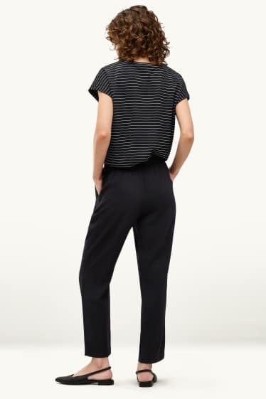 Dona - Pantalons de tela - mid waist - tapered fit - negre