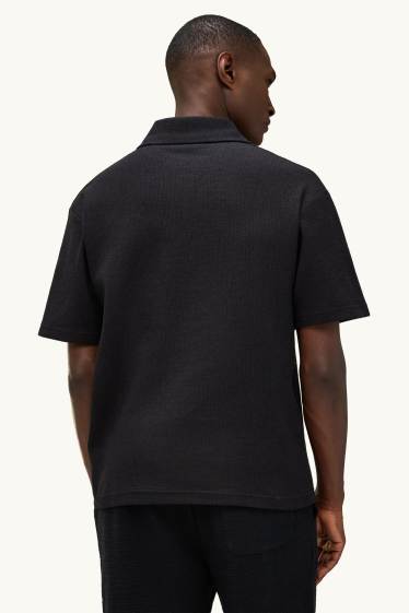 Heren - Gebreid poloshirt - relaxed fit - zwart