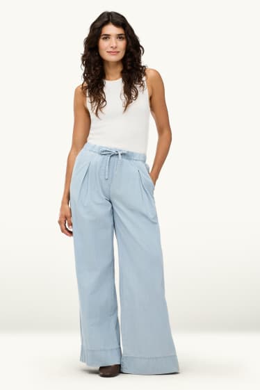 Dona - Pantalons de tela - mid waist - palazzo - blau clar