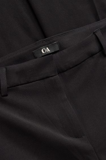 Dona - Pantalons de tela - mid waist - acampanats - negre