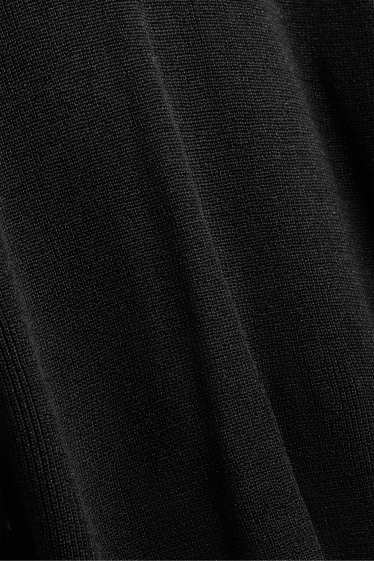 Femmes - Pull avec encolure en V - finition brillante - noir