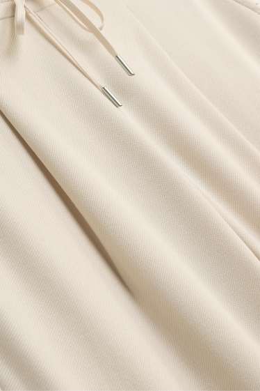 Dona - Pantalons de tela - mid waist - tapered fit - crema