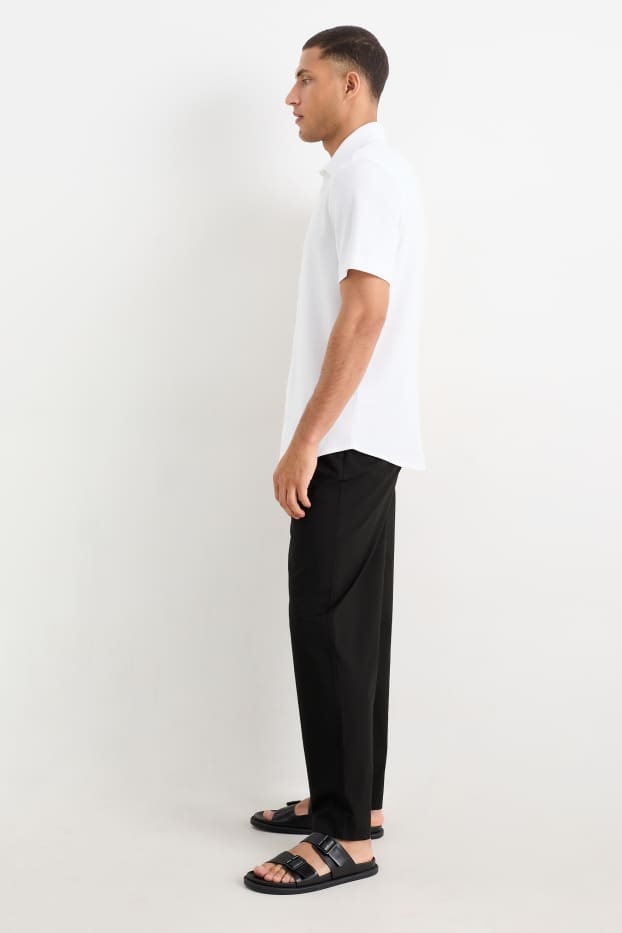 Pánské - Kalhoty chino - tapered fit - černá