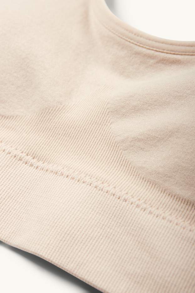 Dámské - Sportovní podprsenka - s vycpávkami - bezešvá - světle béžová