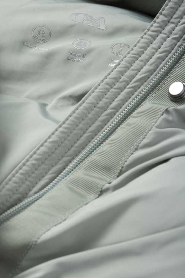 Women - Quilted coat with hood - light green