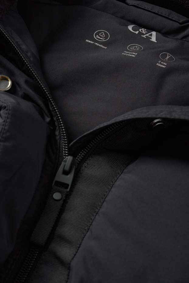 Dona - Jaqueta embuatada amb caputxa - resistent a l’aigua - negre