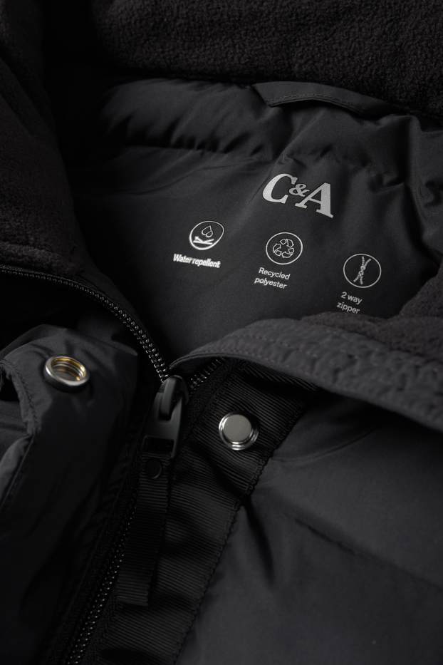 Dona - Abric embuatat amb caputxa - resistent a l’aigua - negre