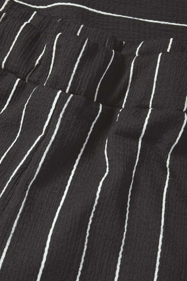 Dames - Broek van jersey - mid waist - loose fit - gestreept - zwart / wit