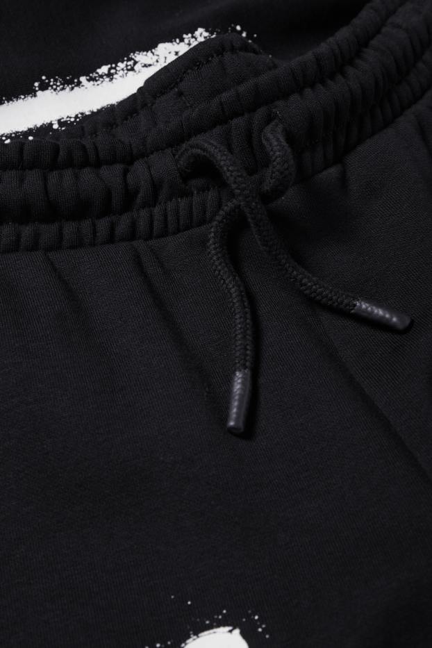 Nen - Halloween - esquelet - pantalons de xandall - brilla en la foscor - negre