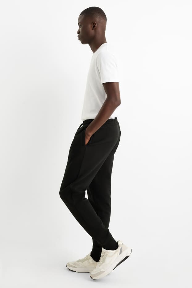 Pánské - Teplákové kalhoty - černá