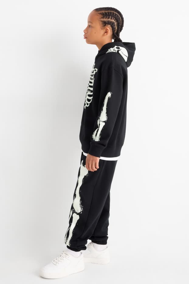 Nen - Halloween - esquelet - pantalons de xandall - brilla en la foscor - negre