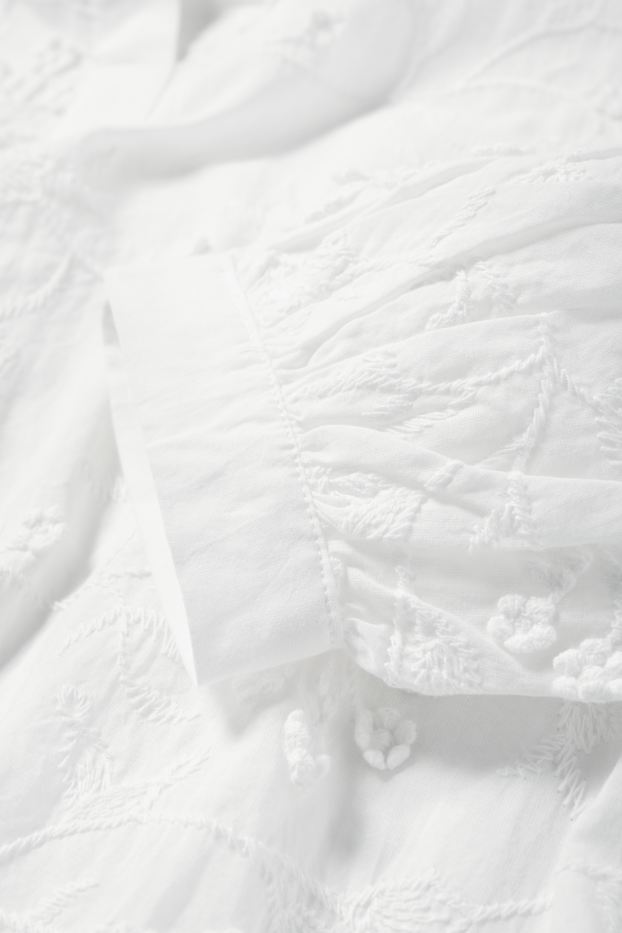 Dona - Brusa amb coll en punta - de flors - texturada - blanc