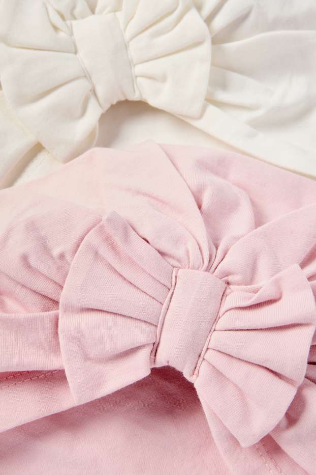 Bebeluși - fete - Multipack 2 buc. - căciulă tip turban - alb / roz