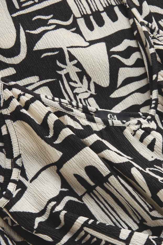 Femei - Salopetă cu decolteu în V și curea - cu model - negru / alb