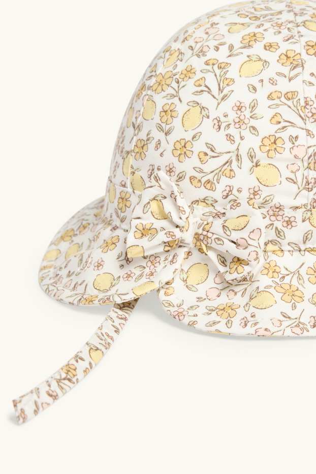 Baby: meisjes - Bloemetje en citroen - babyhoed - crèmekleurig