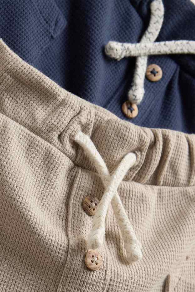 Baby: jongens - Set van 2 - babyjoggingbroek - met structuur - blauw / beige
