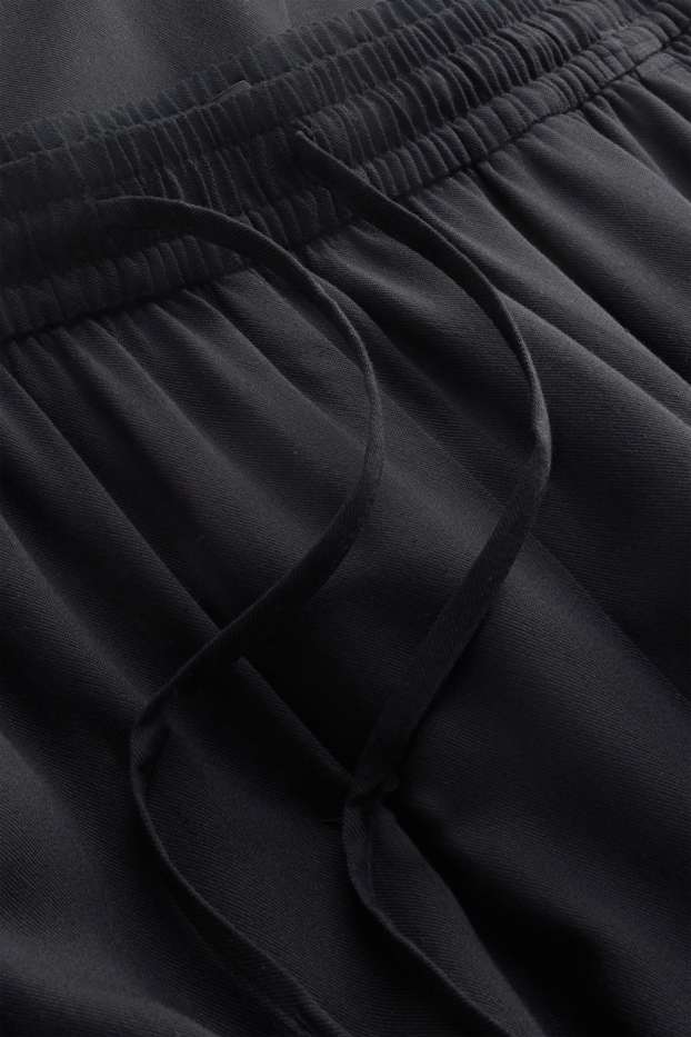 Dona - Pantalons de tela - mid waist - tapered fit - negre