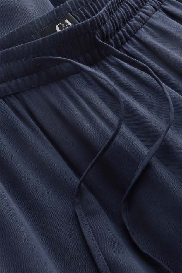 Dona - Pantalons de tela - mid waist - tapered fit - blau fosc