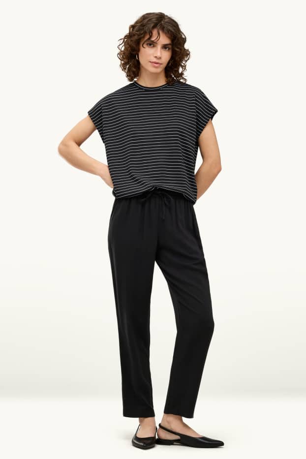 Dona - Pantalons de tela - mid waist - tapered fit - negre