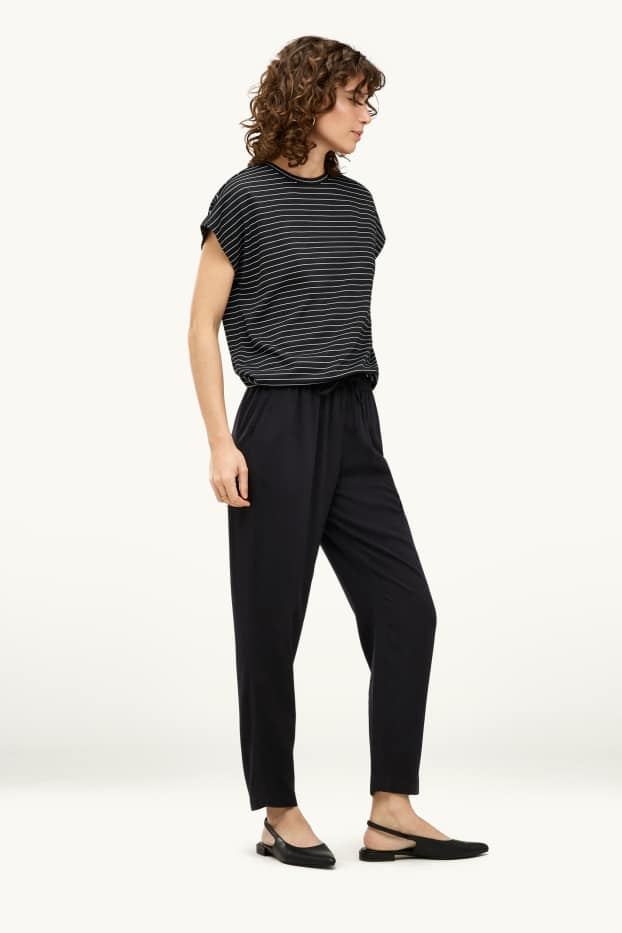 Dona - Pantalons de tela - mid waist - tapered fit - negre