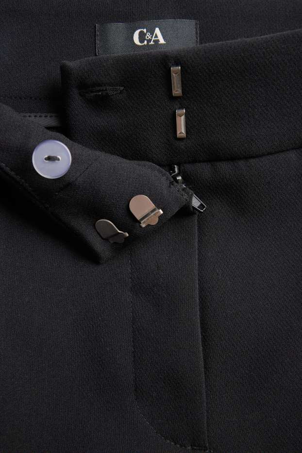 Dona - Pantalons de tela - mid waist - acampanats - negre