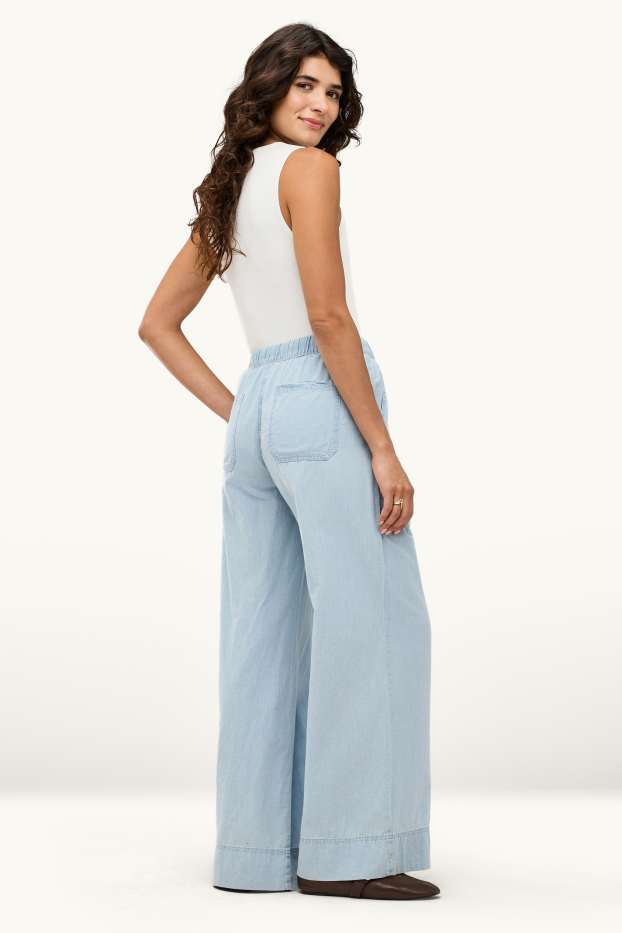 Dona - Pantalons de tela - mid waist - palazzo - blau clar