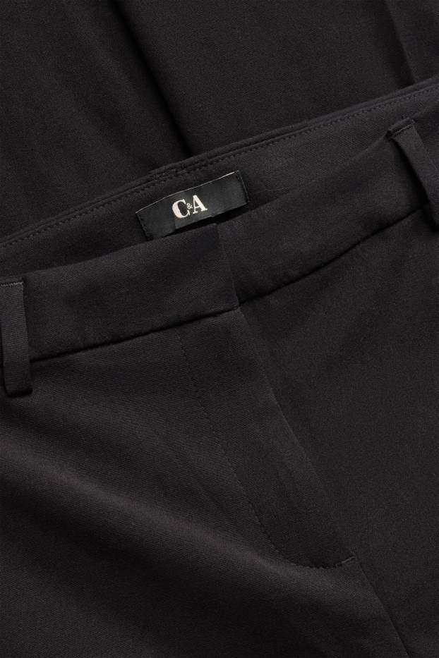 Dona - Pantalons de tela - mid waist - acampanats - negre