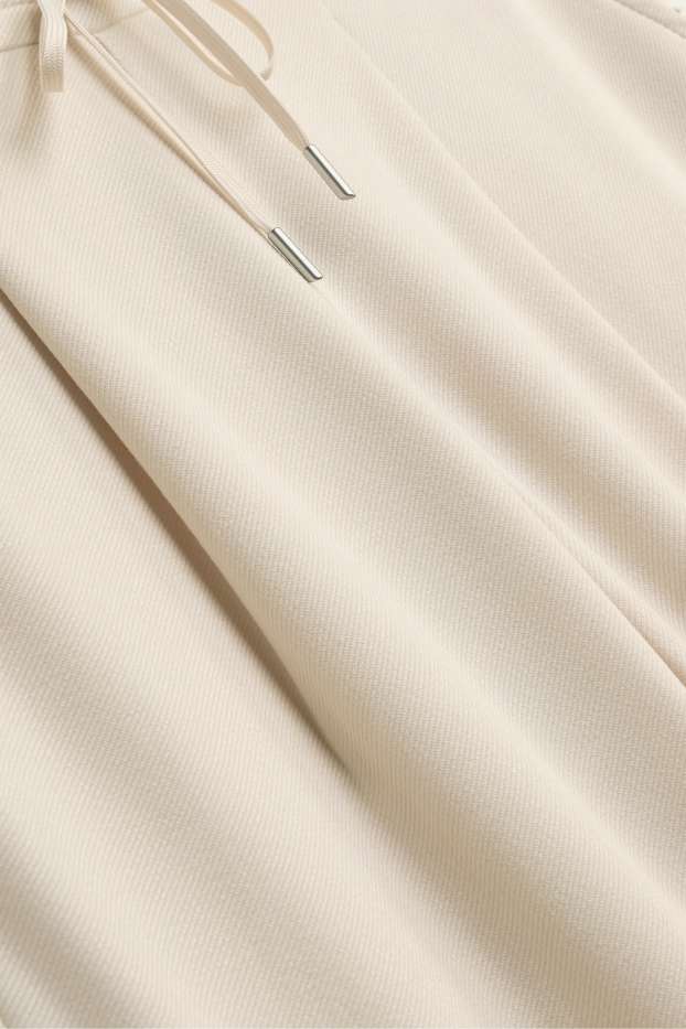 Dona - Pantalons de tela - mid waist - tapered fit - crema