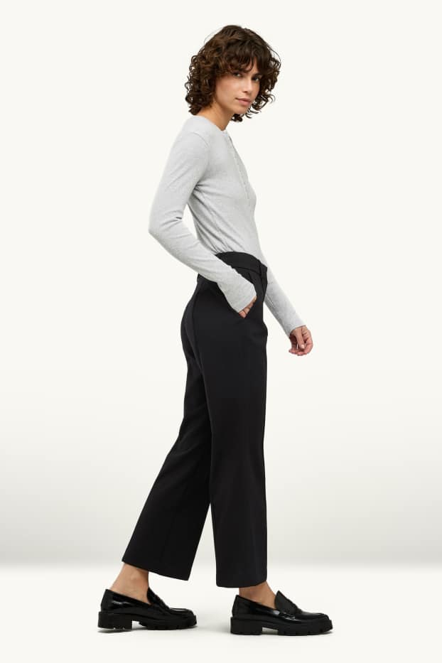 Femei - Pantaloni de stofă - talie medie - evazați - negru