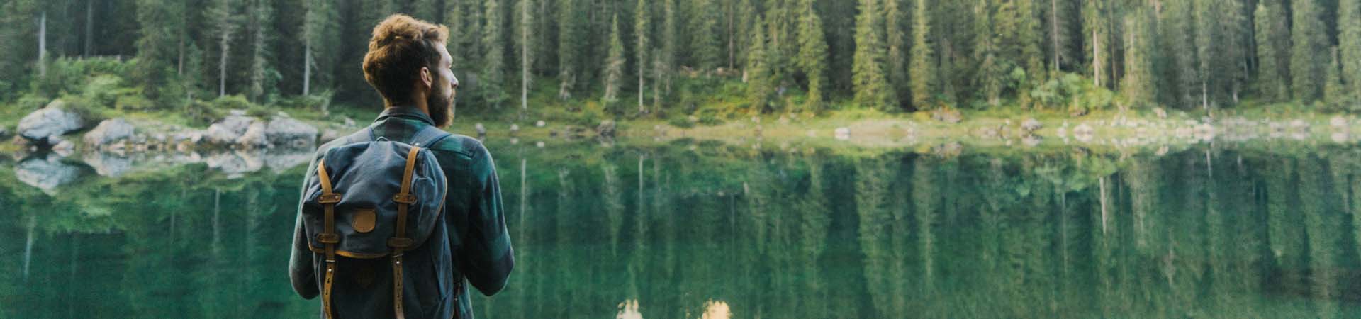 Hiker taking a break in front of a mountain landscape.