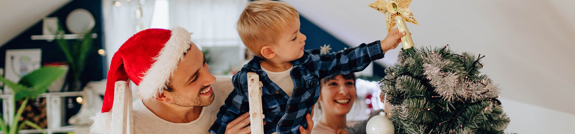 Christmas traditions – families decorating the Christmas tree together.