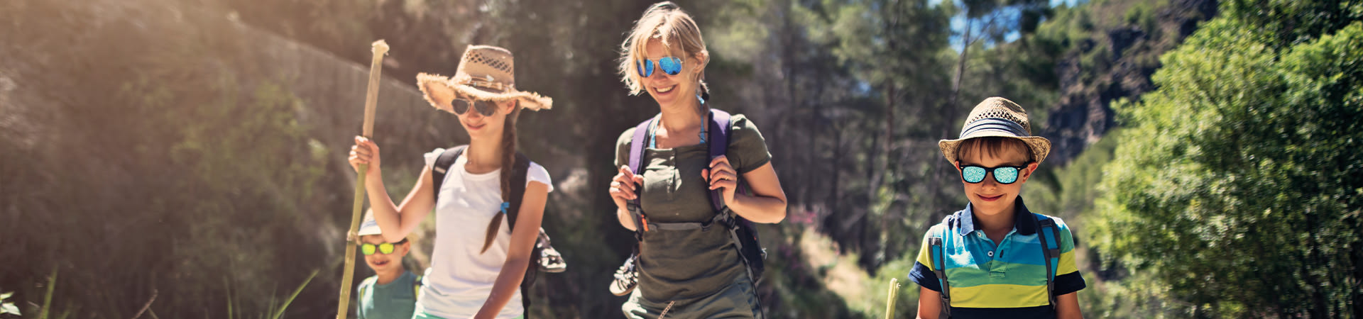 Eco-friendly holidays: a family hiking in the mountains.