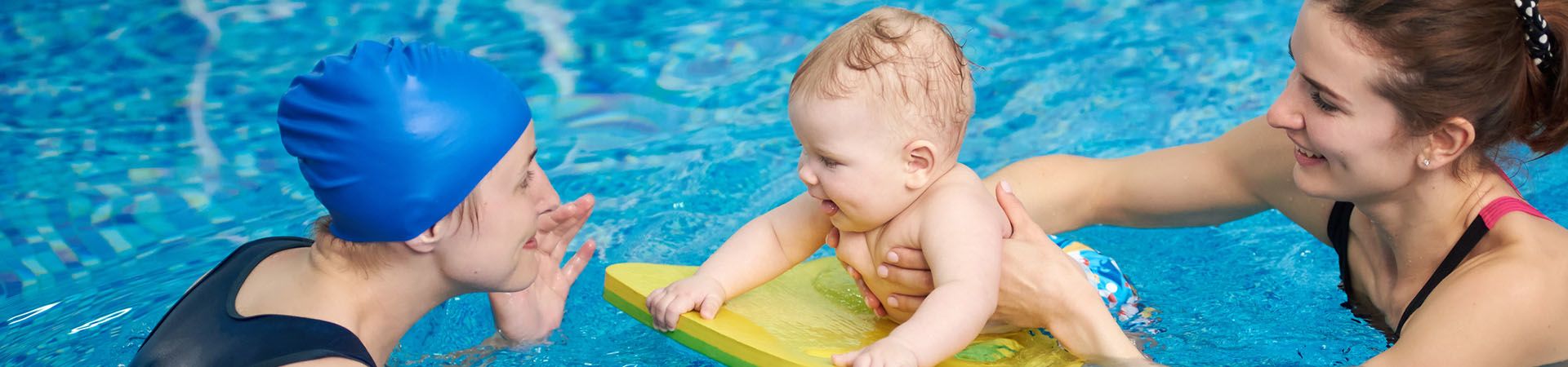 Mother enjoying the closeness with her child during baby swimming.
