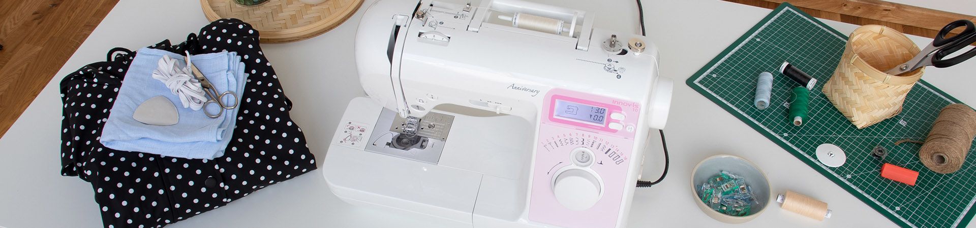 Workstation with sewing tools and a raincoat.