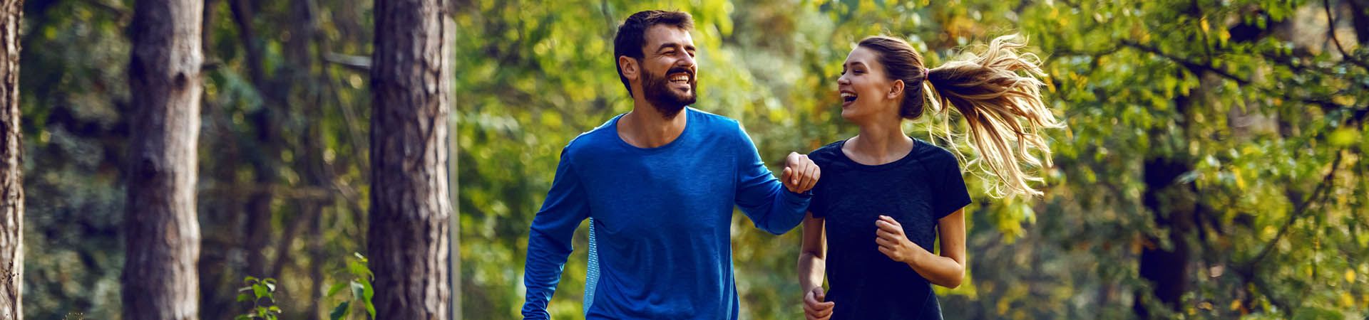 Improving running technique - Friends jogging together in the forest.