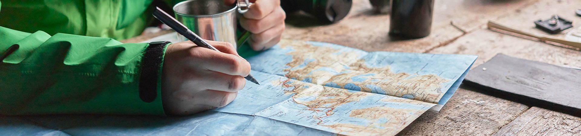 Hiker plans his hiking route using a map.