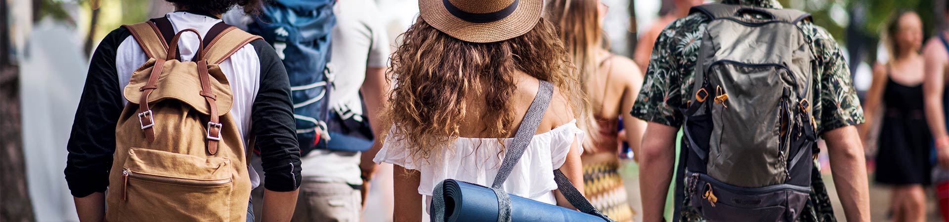 Festival checklist: festival visitors with luggage on the way to their campsite.