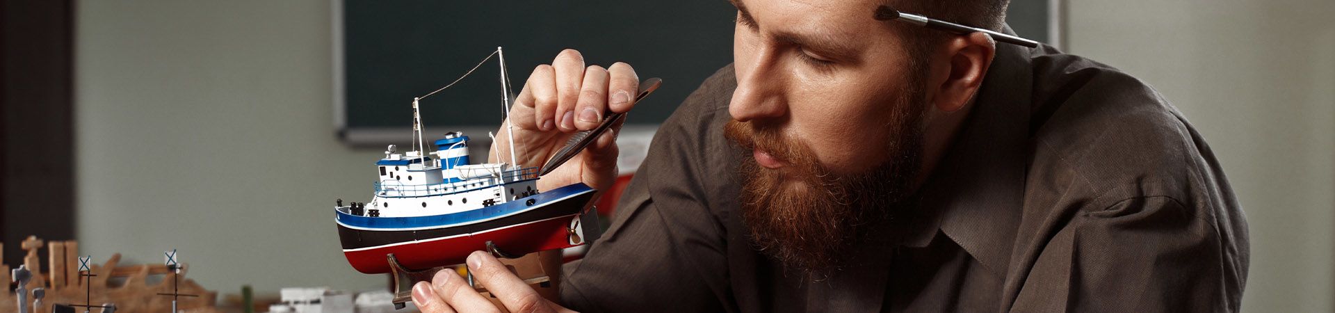 Model making: Man working on his model ship.