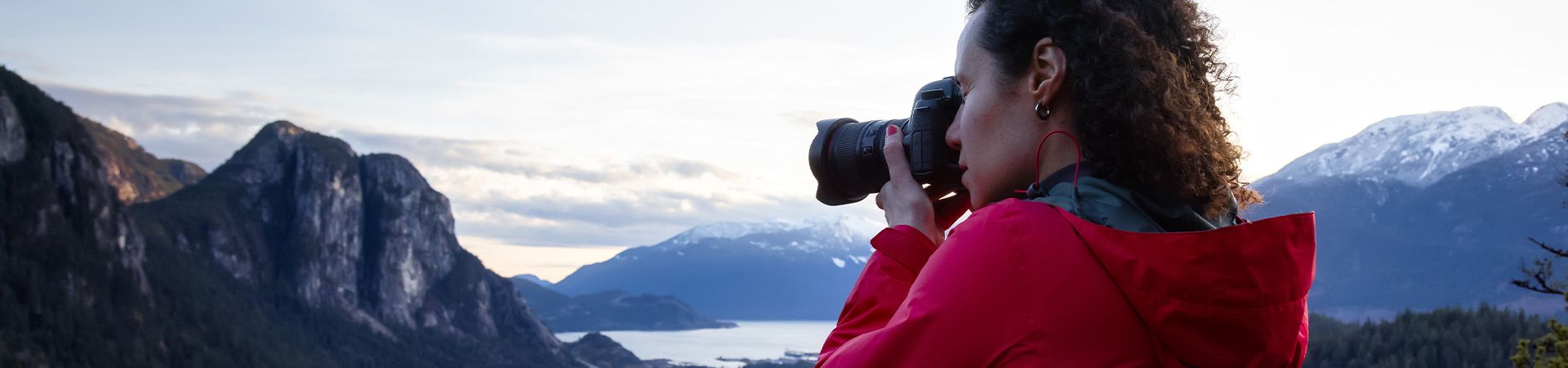 Landscape photography: Woman photographing a mountain landscape.