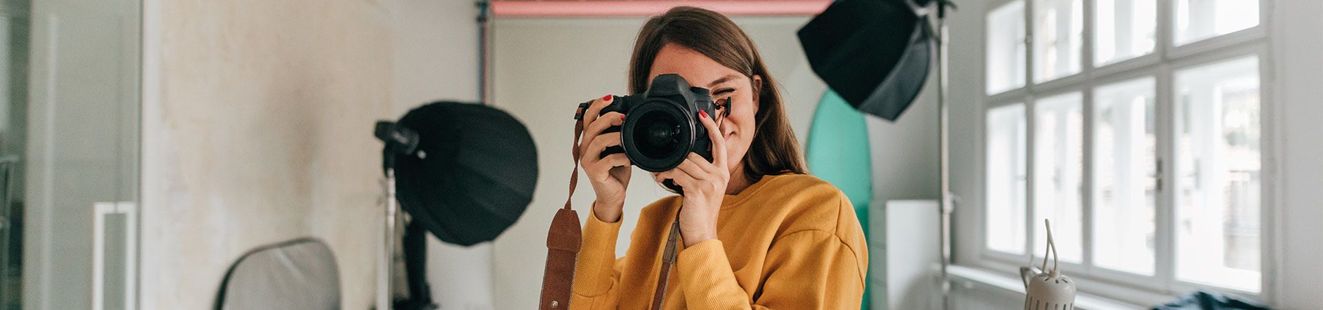 The different types of photography – a photographer taking photos in a photo studio.