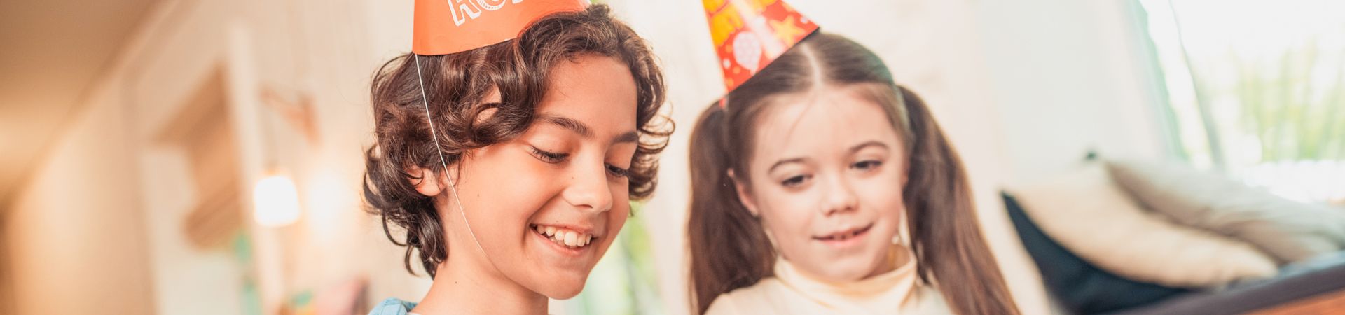 Children's gift from 6 years old. Boy opening his birthday present with his sister.