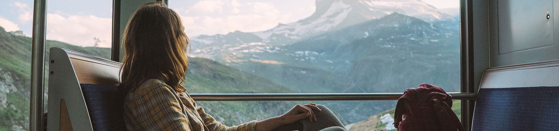 Eco-travel: a woman travelling on a train in Switzerland.