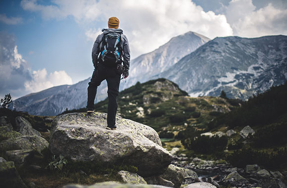 Hiking alone - a hiker enjoys the view during a mountain hike.