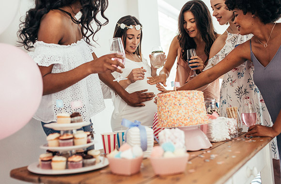 Women touch the baby bump.